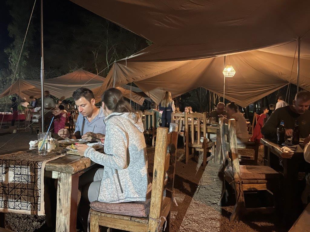 Other guests enjoying dinner while they discuss What’s a Tanzania Safari really like?