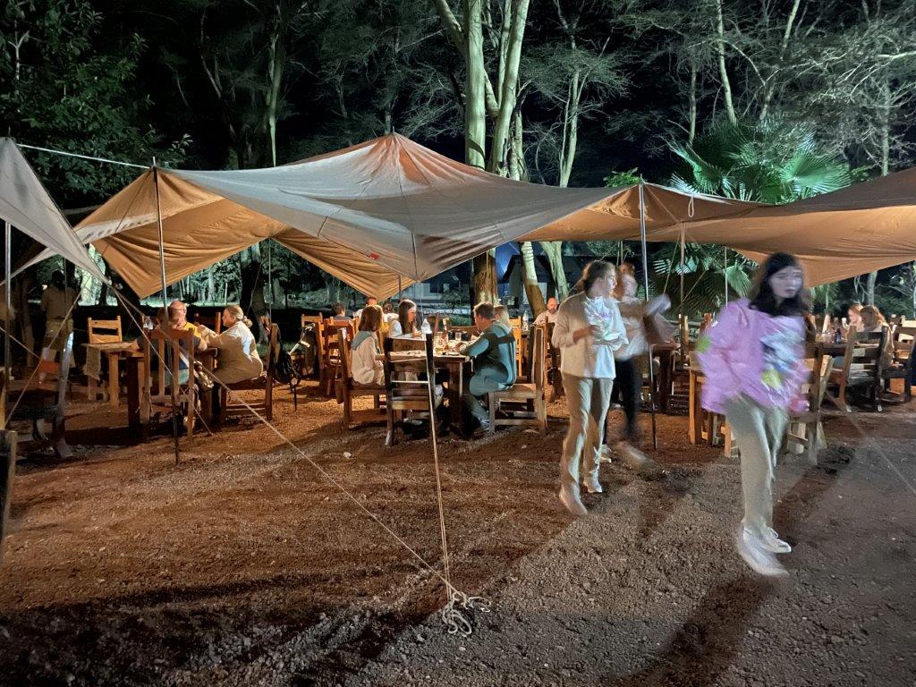 A view of the dining hall with guests talking about their views of What’s a Tanzania Safari really like?