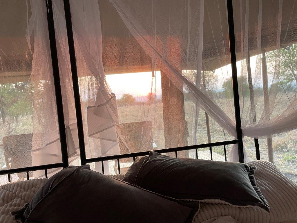 Our sunrise view from our bed - now this is a great example of What’s a Tanzania Safari really like?