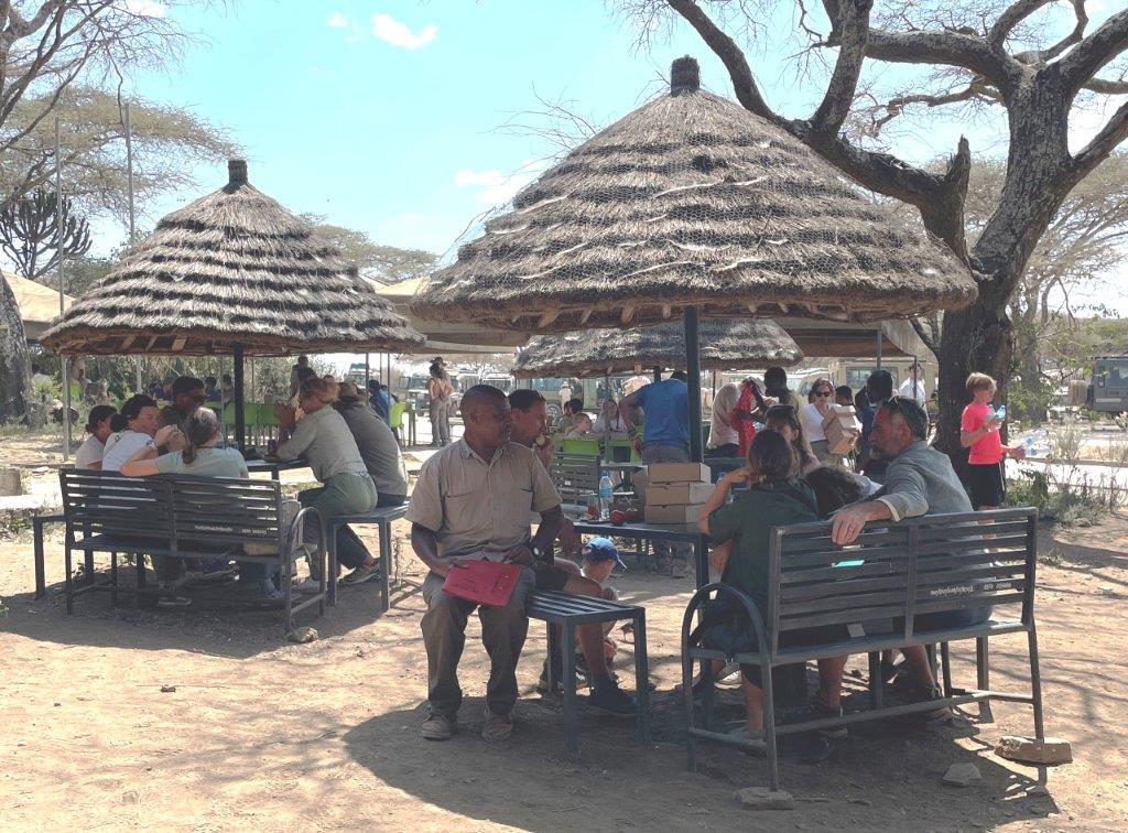 Lunch at the Serengeti Entrance - the safari goers are all sharing stories and discussing What’s a Tanzania safari really like?