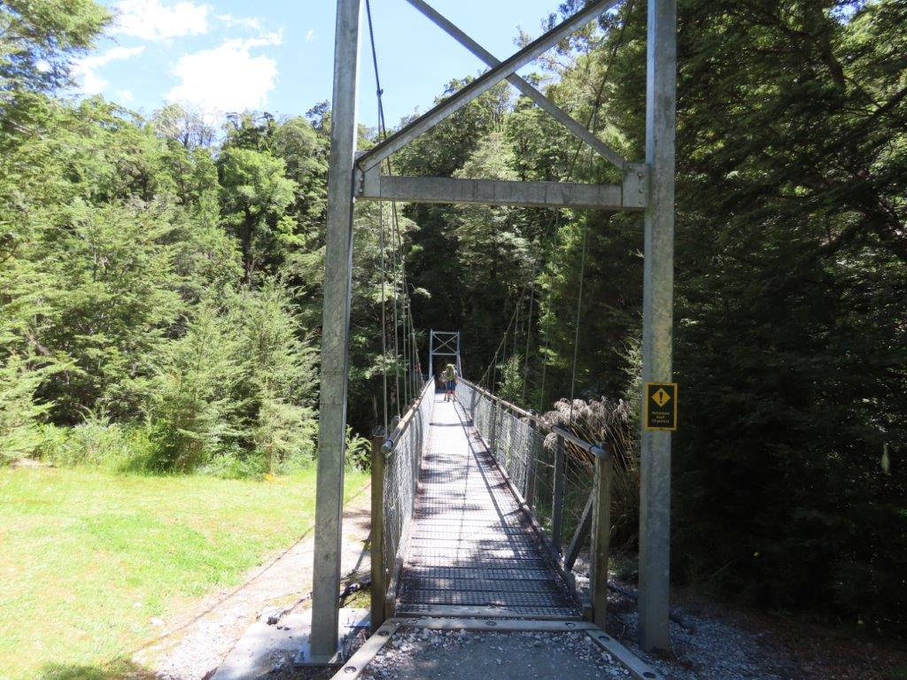 Suspension bridge crossing a forested river on the Routeburn Track near Glenorchy, a popular option for day hikes from Queenstown.