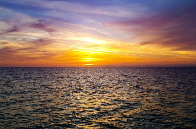 The sun sets over the Southern Ocean off the coast of Kaikoura New Zealand