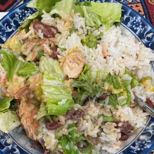 Chicken, beans and lettuce on a bed of white rice.