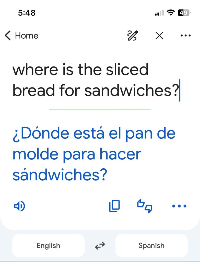 Screen shot of the Google Translate app showing an example translating "Where is the sliced bread for sandwiches?" from English to Spanish.