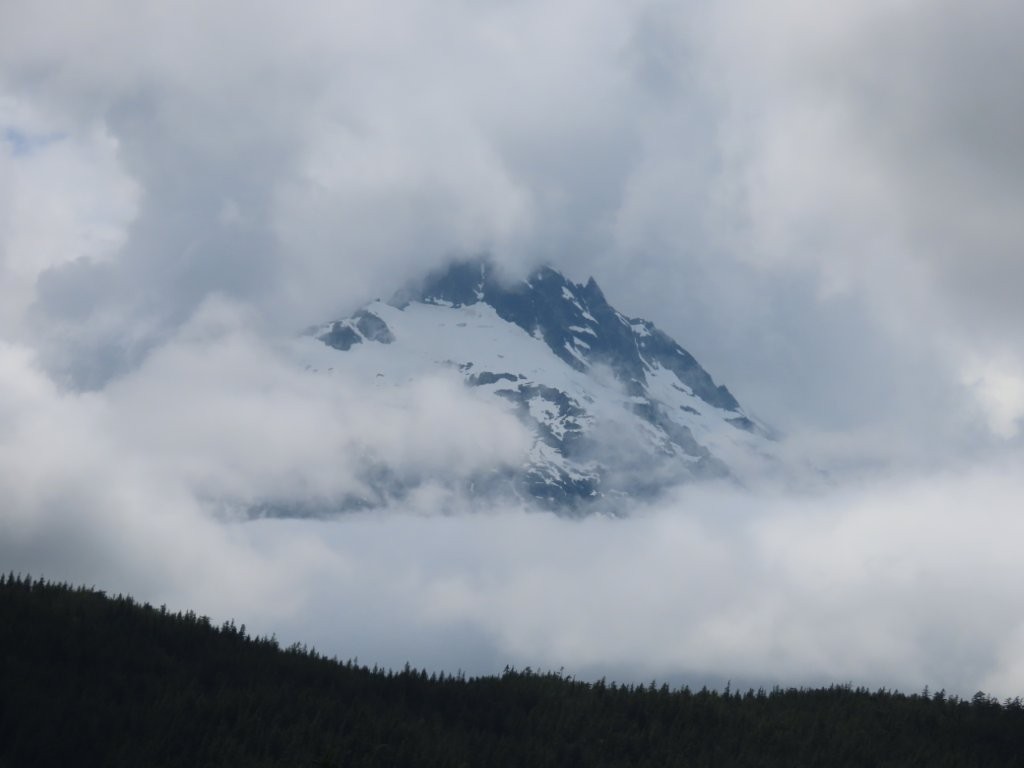 Lots of heavy white clouds create opacity for the views of Mount Tantalus, just north of Vancouver, BC