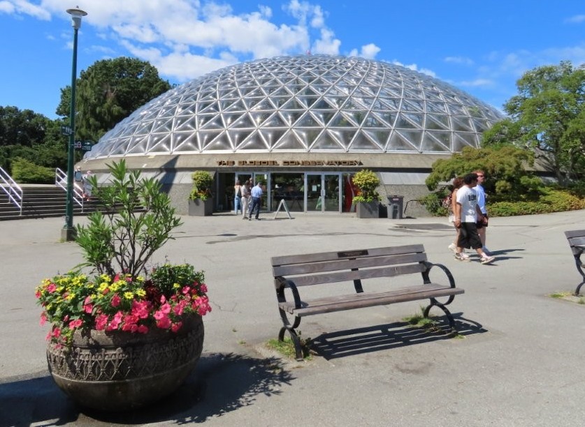 A metal and glass domed building is the Bloedel Conservatory in Vancouver, BC.
