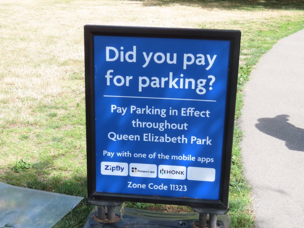 A blue sign with white letters boldly asks "Did you pay for parking?" and reminds you of the consequences if you don't. Pay Parking is required at Queen Elizabeth Park in Vancouver.