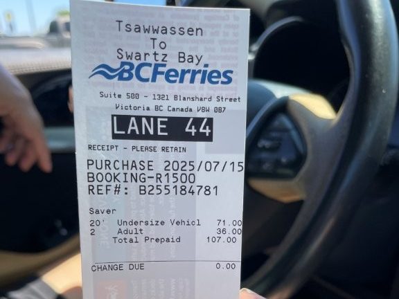 Close-up of a BC Ferries ticket showing booking info and lane assignment for a car traveling from Tsawwassen to Swartz Bay.