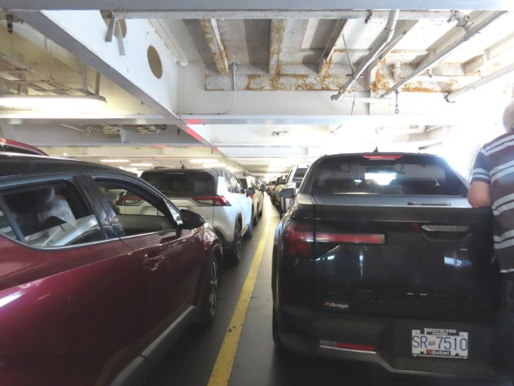 View of tightly packed vehicles on an upper car deck aboard the BC Ferry crossing from mainland BC to Vancouver Island