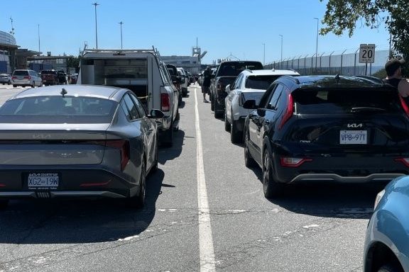 Cars line up in long lines on the pavement, waiting to board the ferry to Vancouver Island.