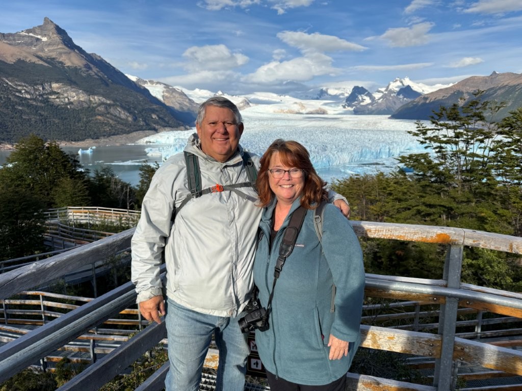 Bill and Kari are dressed warmly as they stand in front of the icy Perito Merino Glacier in Argentina.