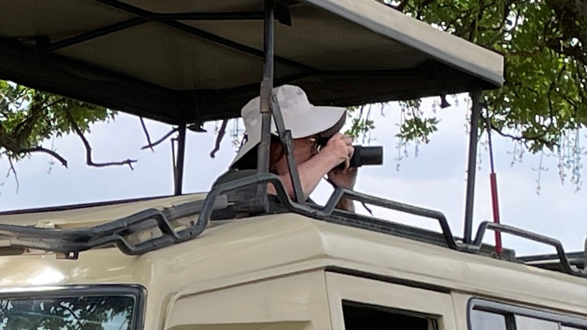 Kari shoots her camera out of the top of the safari vehicle
