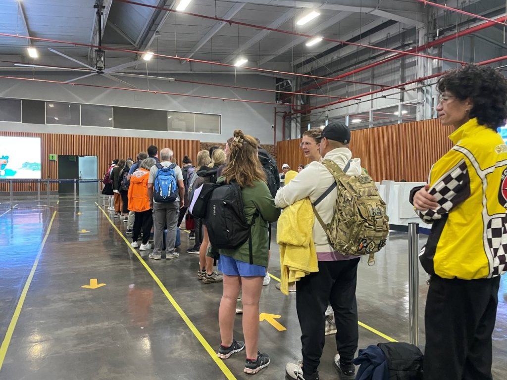 Passengers wait in a long line inside Baltra Airport after landing in the Galapagos Islands. Even after your flight arrives, there are still entry fees, passport checks, and screening steps before the trip really begins.