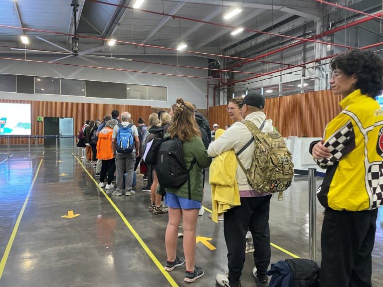 Passengers wait in a long line inside Baltra Airport after landing in the Galapagos Islands. Even after your flight arrives, there are still entry fees, passport checks, and screening steps before the trip really begins.