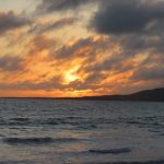 The sun sets behind dark clouds over the ocean near Puerto Villamil on Isabela Island. Evenings on Isabela Galapagos felt slower, quieter, and more relaxed than anywhere else we visited.