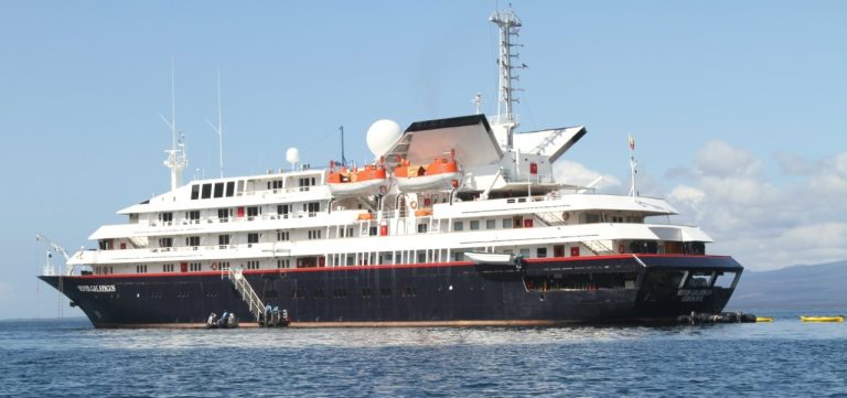 The Silversea Explorer Galapagos liveaboard floats on calm blue water with multiple decks, lifeboats, and expedition gear visible. Seeing the ship helps readers picture the cruise-style option when comparing a Galapagos liveaboard vs land-based trip.