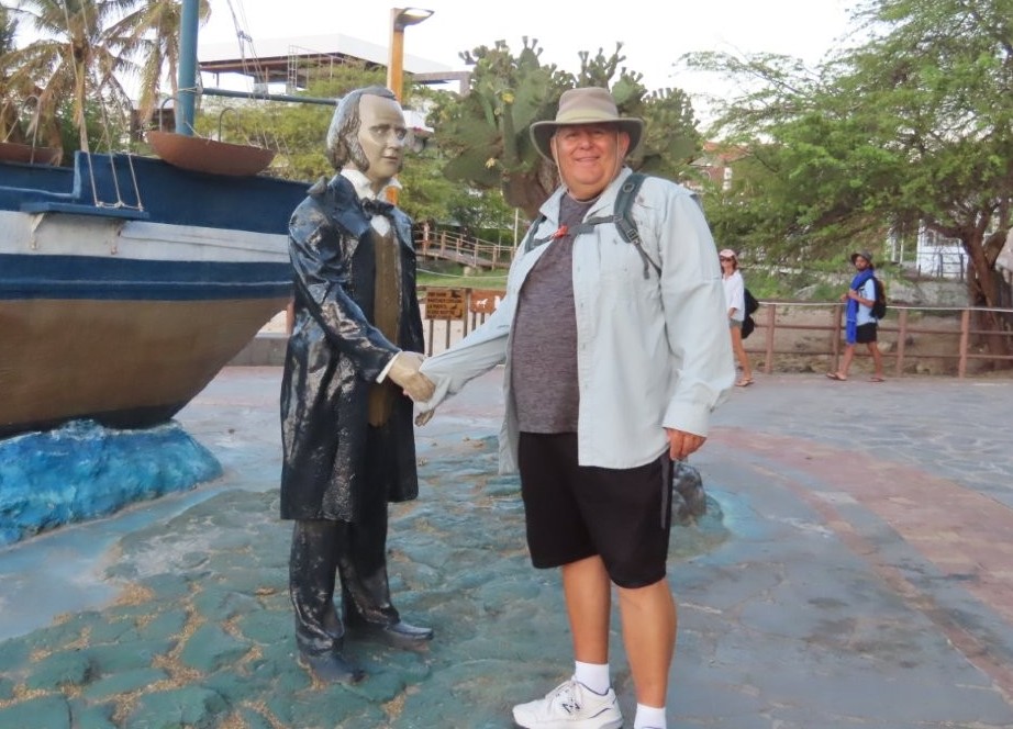 Posing beside the Charles Darwin monument on the waterfront in Puerto Baquerizo Moreno, a fun stop while exploring San Cristóbal on foot.