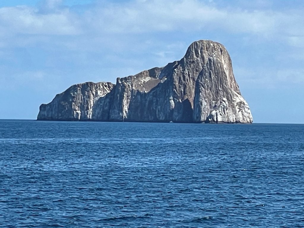 Scenic view of gray and white Kicker Rock surrounded by blue Pacific waters in the Galapagos.