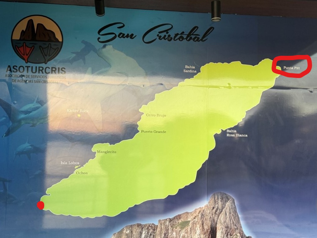 Photo of a map of San Cristobal Island. The location of Punta Pitt is circled in red on the far right. A red dot on the far left indicates Puerto Baquerizo Moreno, our starting point.