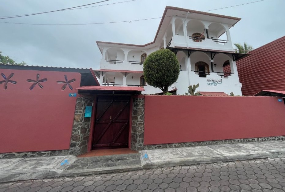 A modern waterfront property sits along the rocky shoreline with palm trees, terraces, and ocean views stretching across the bay. Villa Escalesia stands out for travelers looking for a luxury stay in Santa Cruz Galapagos with a quieter waterfront setting right in Puerto Ayora.
