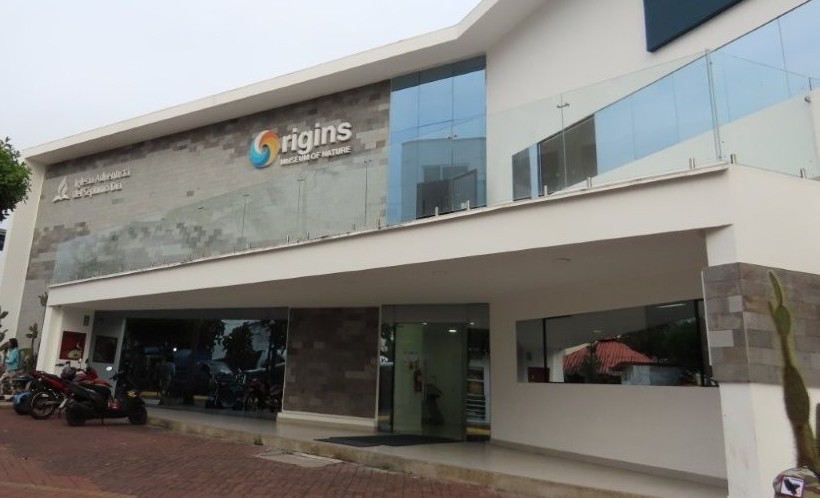 A modern white and gray building with large glass windows houses the Origins Museum of Nature in Puerto Ayora. The Origins Museum is one of the lesser-known free things to do on Santa Cruz Island for travelers interested in science and natural history exhibits.