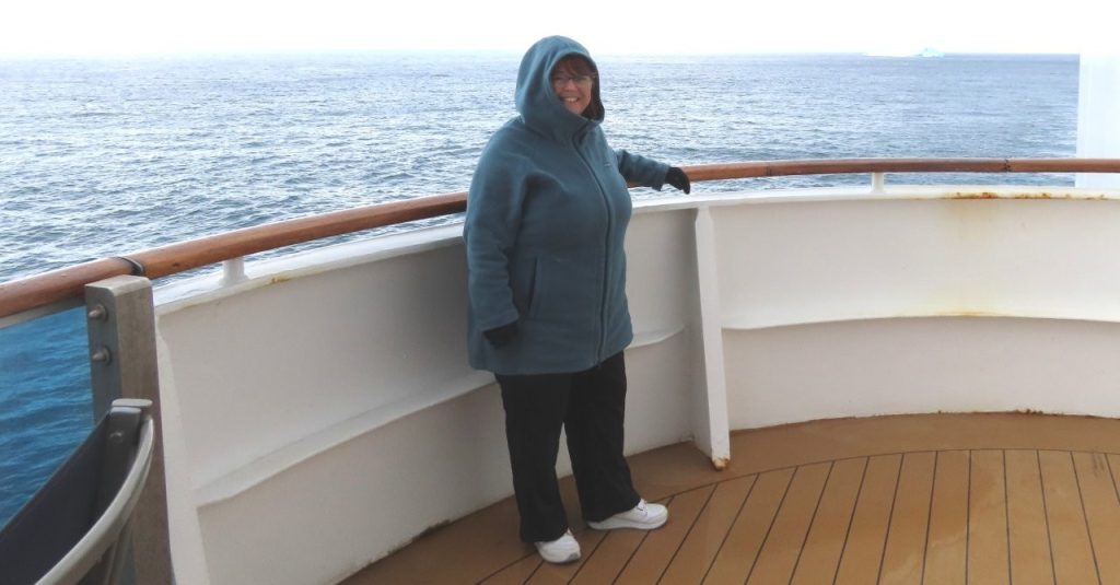 Kari wears a Columbia fleece jacket over her base layer while standing on the deck of the cruise ship. This became her everyday outfit during four days of scenic cruising through Antarctica.