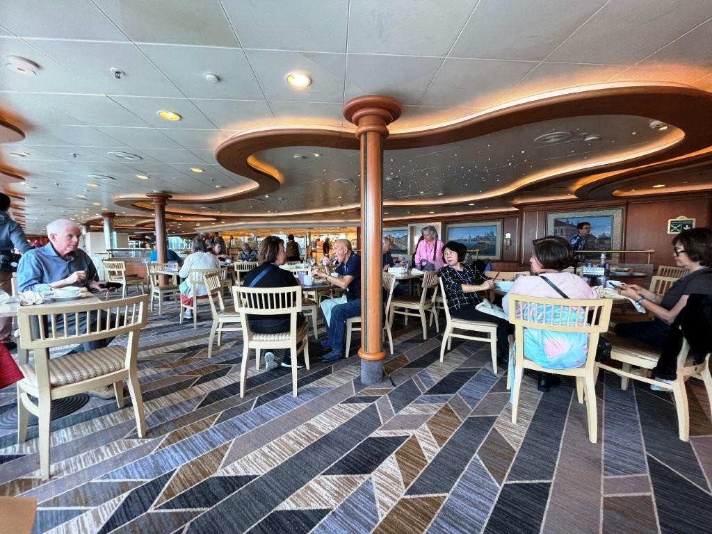Inside the seating area for the World Fresh Marketplace Buffet aboard Sapphire Princess. The buffet offers a wide variety of breakfast, lunch, dinner, and snack options throughout the day.