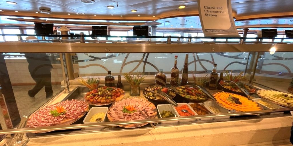 A Charcuterie station in the Buffet offers an assortment of sliced cheeses, meats and olives.