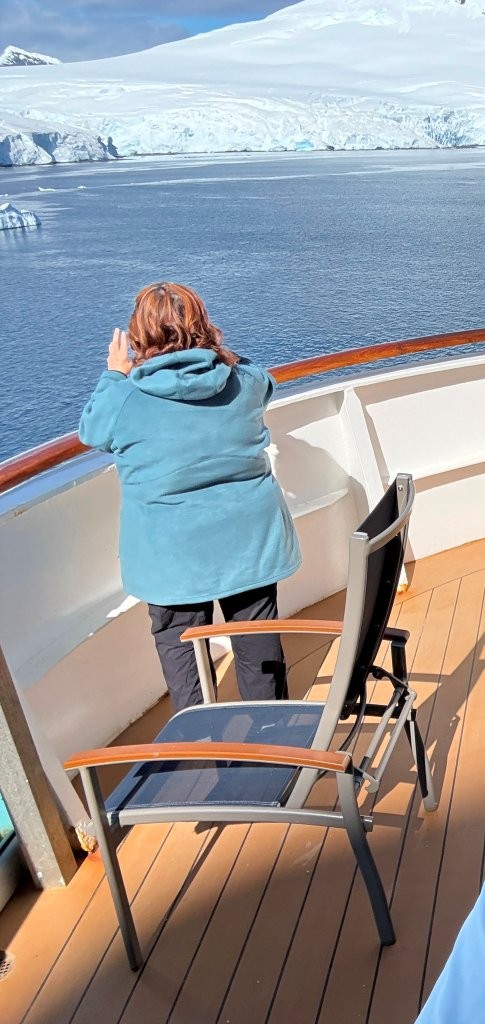 Kari photographs a glacier from the private balcony of the cruise ship. She loved being able to step outside the moment the light changed and return indoors whenever she wanted.