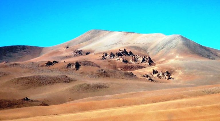 Softly colored volcanic hills and rocky outcrops roll across a seemingly endless desert horizon. The remote landscapes along Ruta 27 felt untouched and far removed from the busier attractions near town.