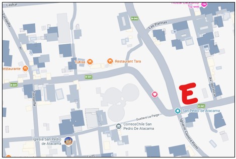 Map showing the location of a free public parking lot just outside the pedestrian streets of San Pedro de Atacama, marked with a red "E." This helps drivers find convenient parking before exploring town on foot.