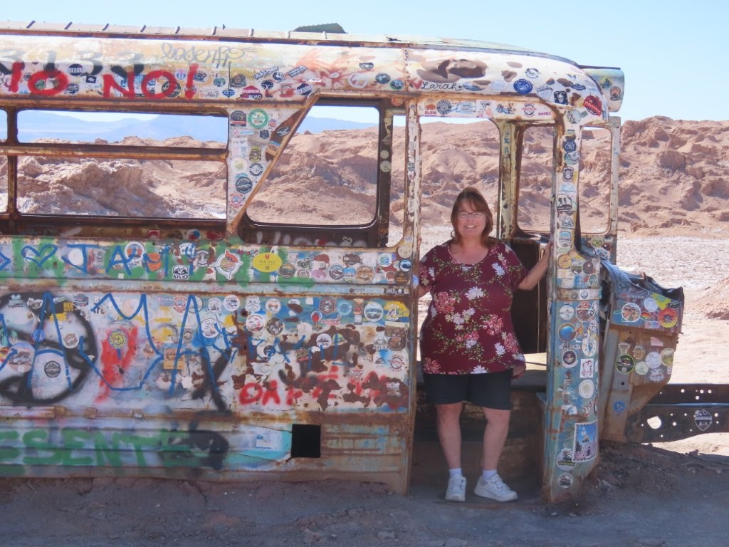 An abandoned, graffiti-covered bus sits alone in the middle of the Atacama Desert after decades of exposure to the elements. Finding it became one of the most memorable stops on our Valle de la Luna drive.