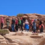 A tour group stands on the rocks, listening to their guide. Exploring Yerbas Buenas involved more climbing and scrambling than I expected.