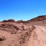 The road winds through colorful desert ridges inside Valle de la Luna. This view gives a sense of what you'll experience during the self-drive route.