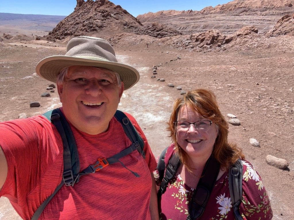 Kari and Bill stopped to take a selfie at the top of a hill in the Valle de la Luna. The red dust and rocks show how barren the land was.