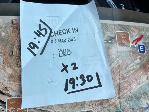 A receipt is stapled to a map with times written on it in black sharpie. This is the key to getting into the Ckari Mirador to the sunset.