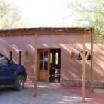 A landscaped pathway winds between adobe-style buildings and native trees at Naturalis Hotel. The quiet garden setting is a big part of why this property stands out from many San Pedro de Atacama hotels.