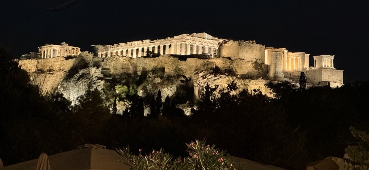 The illuminated Acropolis rises above Athens, with the Parthenon and surrounding ancient structures glowing against the night sky. This iconic view sets the scene for an Athens itinerary 2 days long, with an optional third day to see even more of the city.