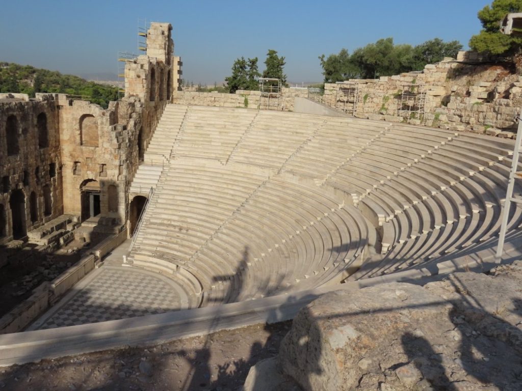 Rows of pale stone seats curve around the ancient Odeon of Herodes Atticus theater on the slope of the Acropolis. Seeing sites like this along the climb gave our guided Acropolis tour much more context than simply heading straight to the Parthenon.