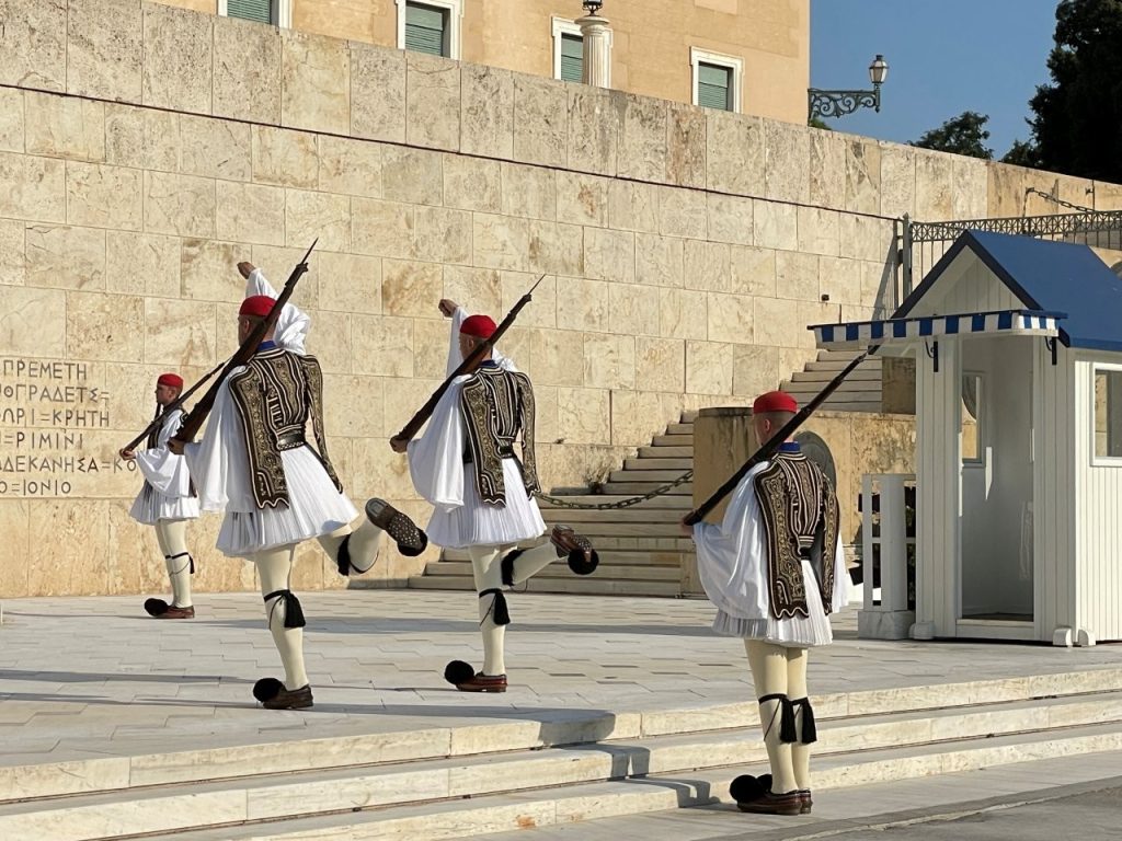 Evzone guards in traditional uniforms perform the Changing of the Guard ceremony outside the Greek Parliament in Athens. Watching their precise movements was one of my favorite stops on our evening walking tour.