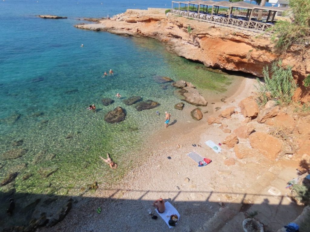 Swimmers float in clear turquoise Aegean water beside a small rocky beach along the Athens Riviera. After seeing how inviting the water was, I’d turn a third day in Athens into a beach day and bring a swimsuit.