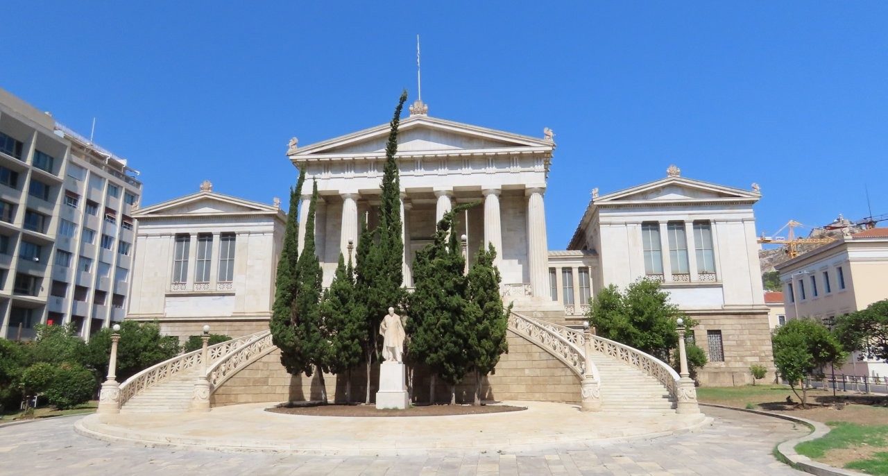 The neoclassical National Library of Greece stands behind its broad staircase and tall columns beneath a clear blue sky. Landmarks like this were easy to see from our sightseeing route even when we didn’t get off the bus.