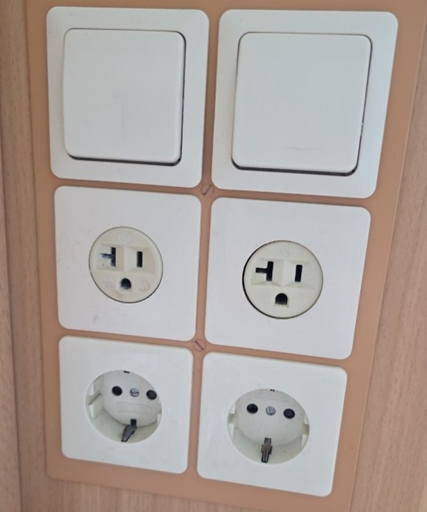 Two U.S.-style and two European-style electrical outlets are grouped together in a panel beside the cabin desk. Because this was the only place to plug things in, the adapter kit we brought was particularly useful.