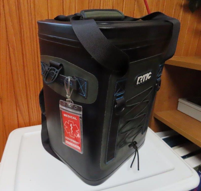 A black cooler with a red Medical Equipment tag is how we manage to travel with medications such as insulin pens that require staying chilled.