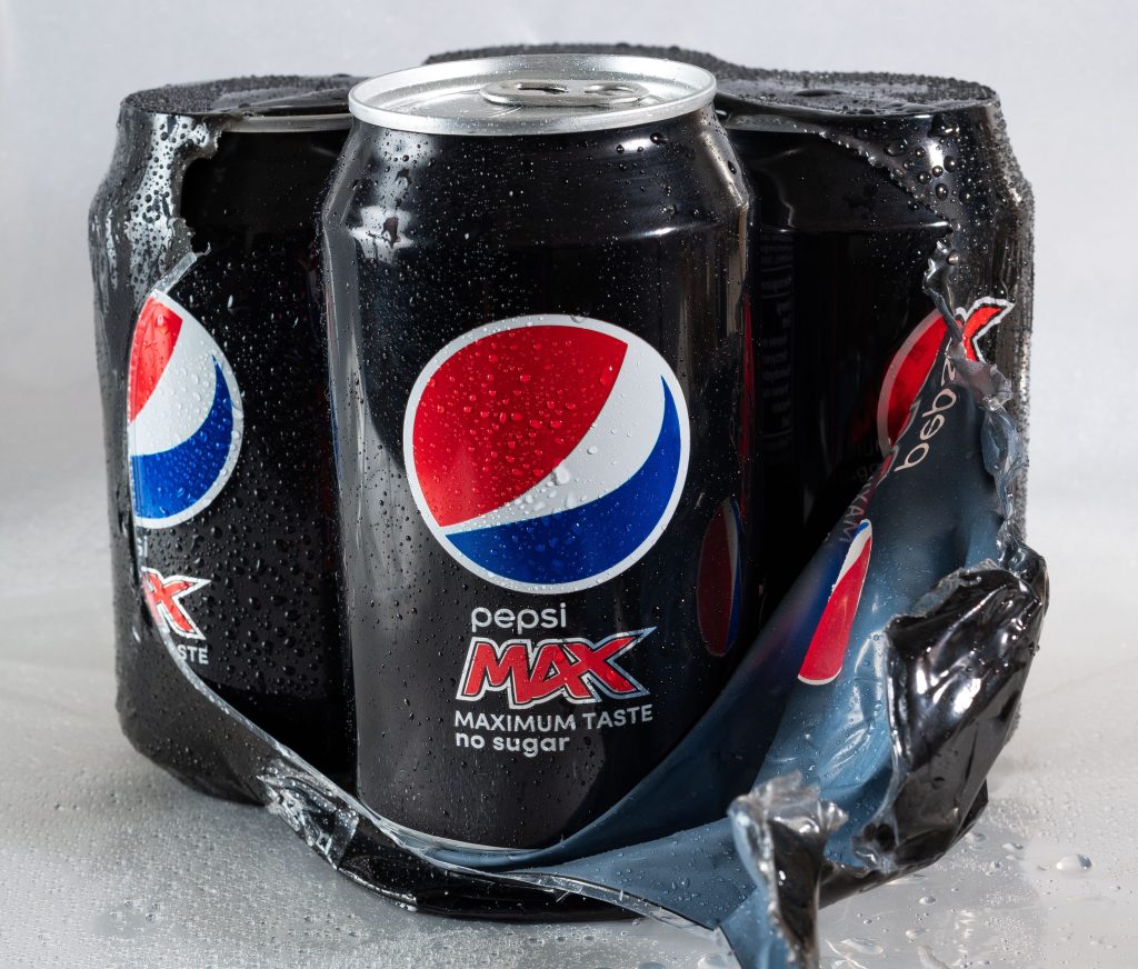 Cold black cans of Pepsi Max sit together in a partially opened multipack, covered with beads of condensation. Bringing Pepsi Max onboard gave Kari a much cheaper alternative to buying individual sodas without a cruise drink package.