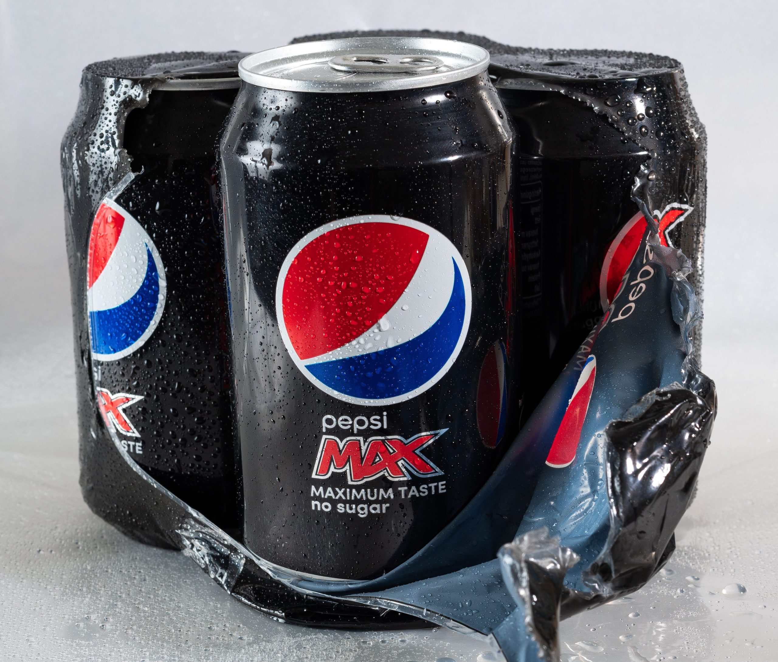A plastic-wrapped set of four Pepsi Max cans of soda pop sweat with condensation. Bringing these on board saved Kari hundreds of dollars instead of buying them from the cruise line.