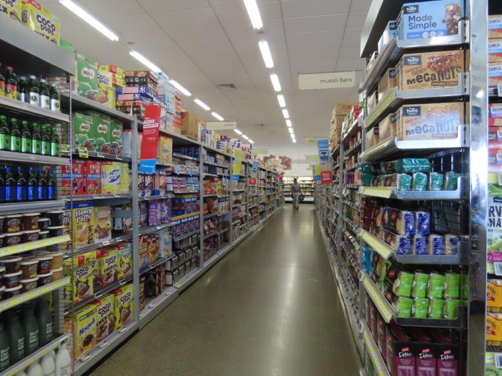 A long aisle in a grocery store has shelves and shelves of food products stacked on them. It was the unfamiliar food and labels in Spanish that gave me the most travel anxiety.
