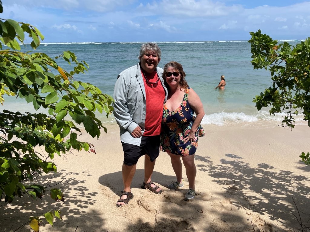 Bill and Kari stand in the golden sand with turquoise waters behind them. This trip to the Bocas del Toro area of Panama gave them an opportunity to snorkel and relax on the beach. 